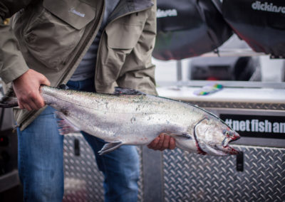 Man holding a freshly caught salmon